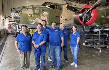 B-25 Mitchell Bomber Photo: Participants pose in front of the historic B-25 Mitchell, honoring WWII aviation history.