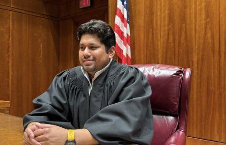 Leadership Tejas participant Joao Rendon dons judicial robes for a photo opportunity.