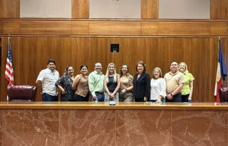 Justice Triana (center) poses with the Leadership Tejas cohort for a group photo.